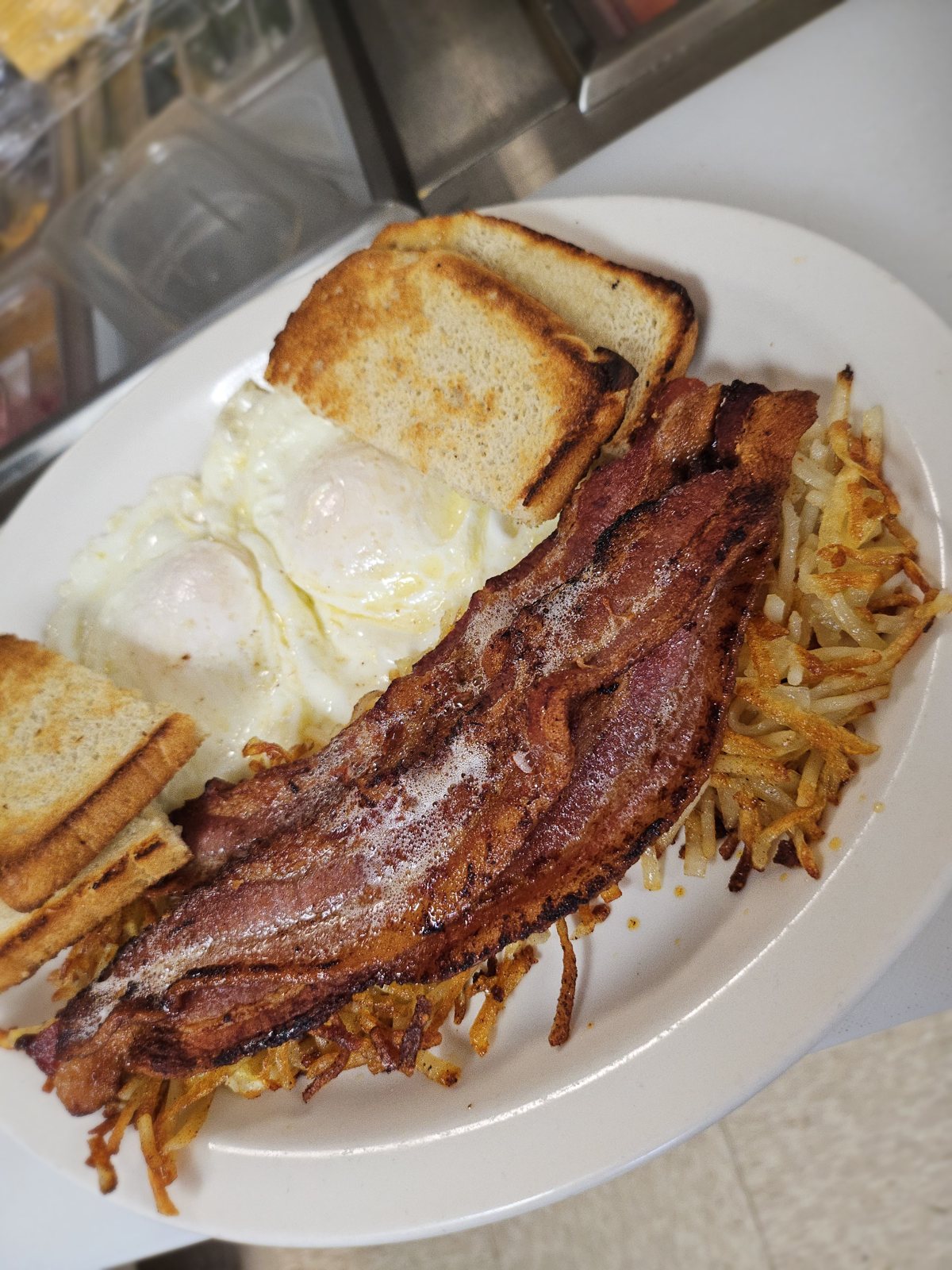 Bacon eggs toast and hash browns