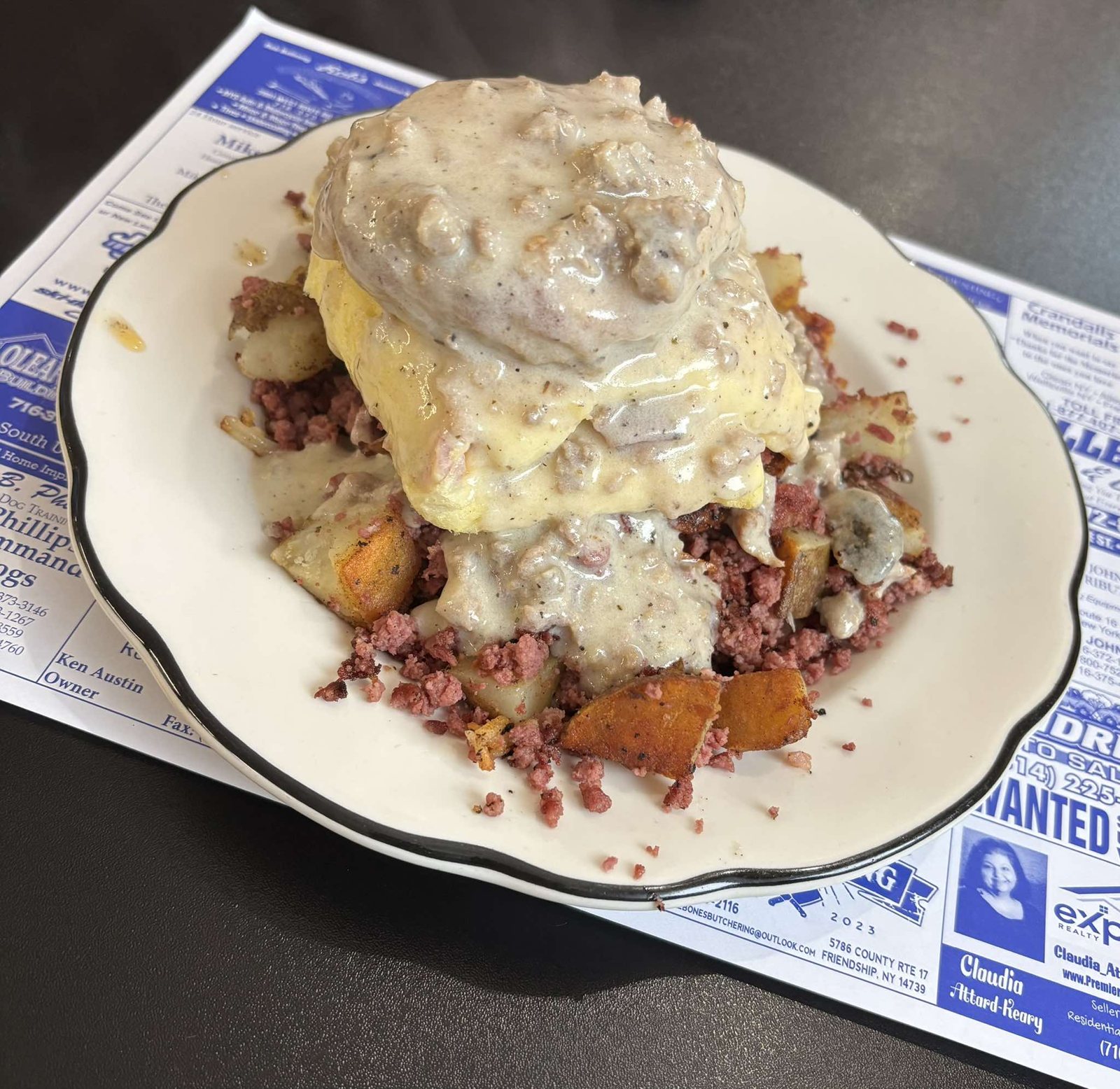 Biscuit and sausage gravy over corned beef hash